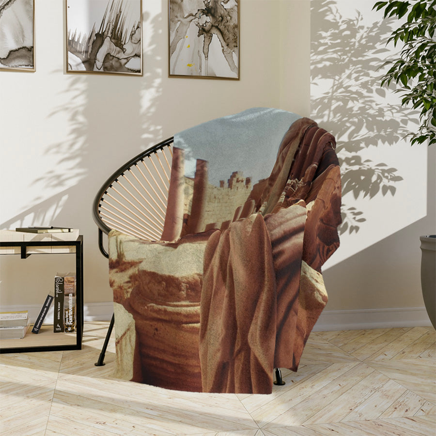 Septimius Severus fleece blanket displayed in a living room setting, showing the detailed golden double exposure artwork of the Roman emperor and Leptis Magna ruins