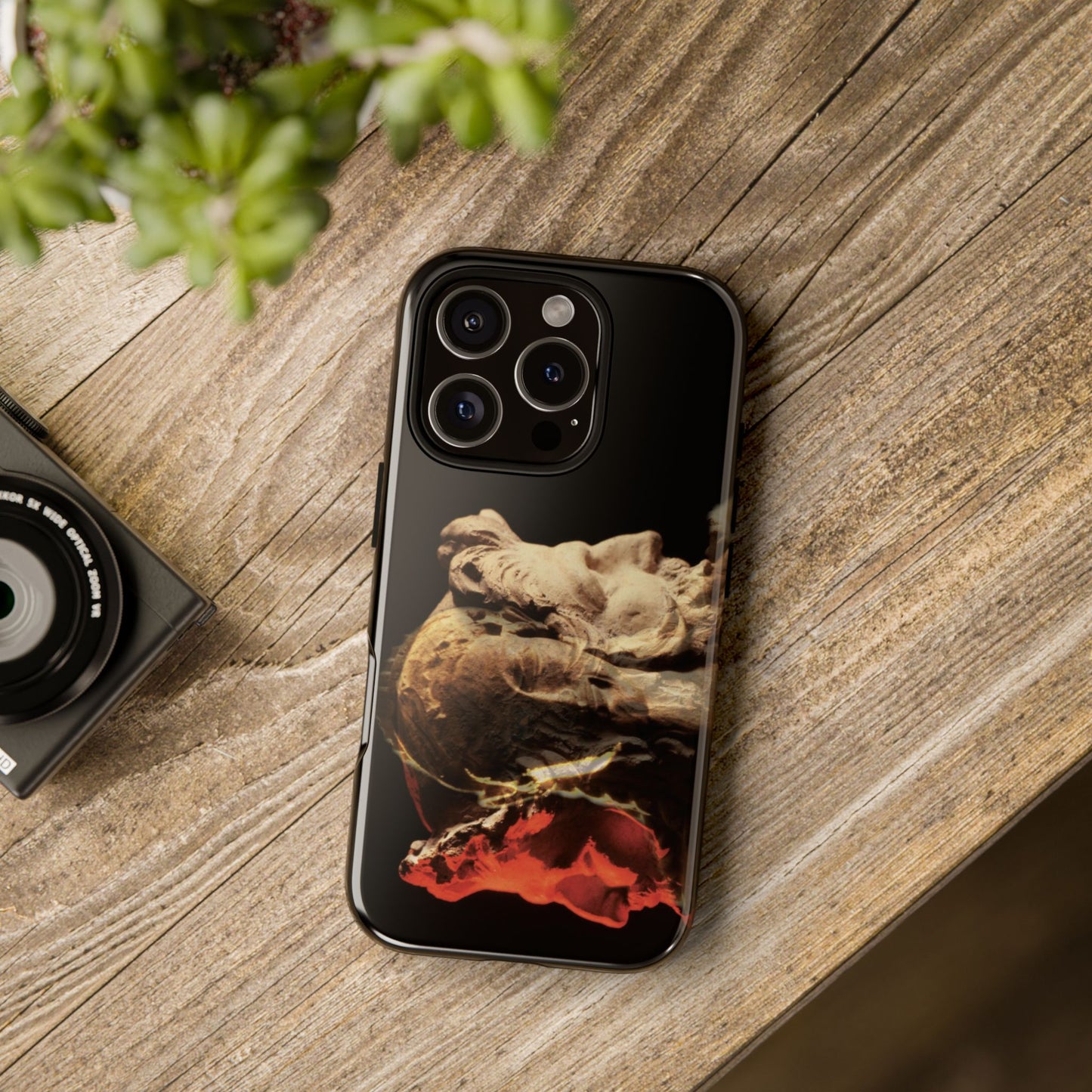 Apollo and two faced Janus tough phone case by Vittorio Storaro, from the La Civiltà Romana collection, shown on a table