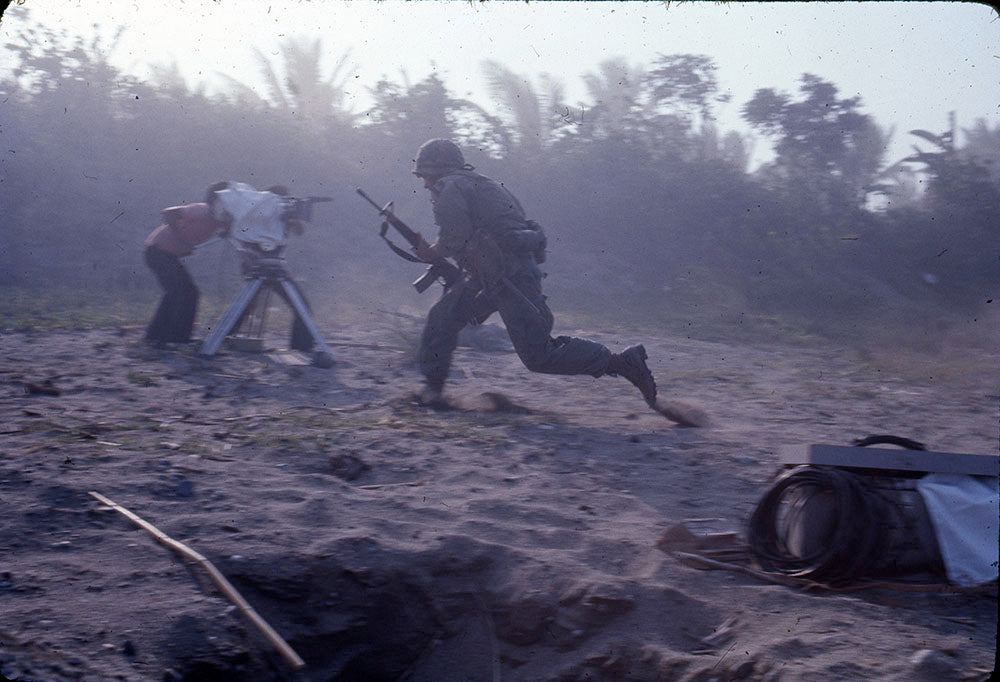 Soldier charging past a camera and operator through smoke on the beach, Apocalypse Now behind-the-scenes photo